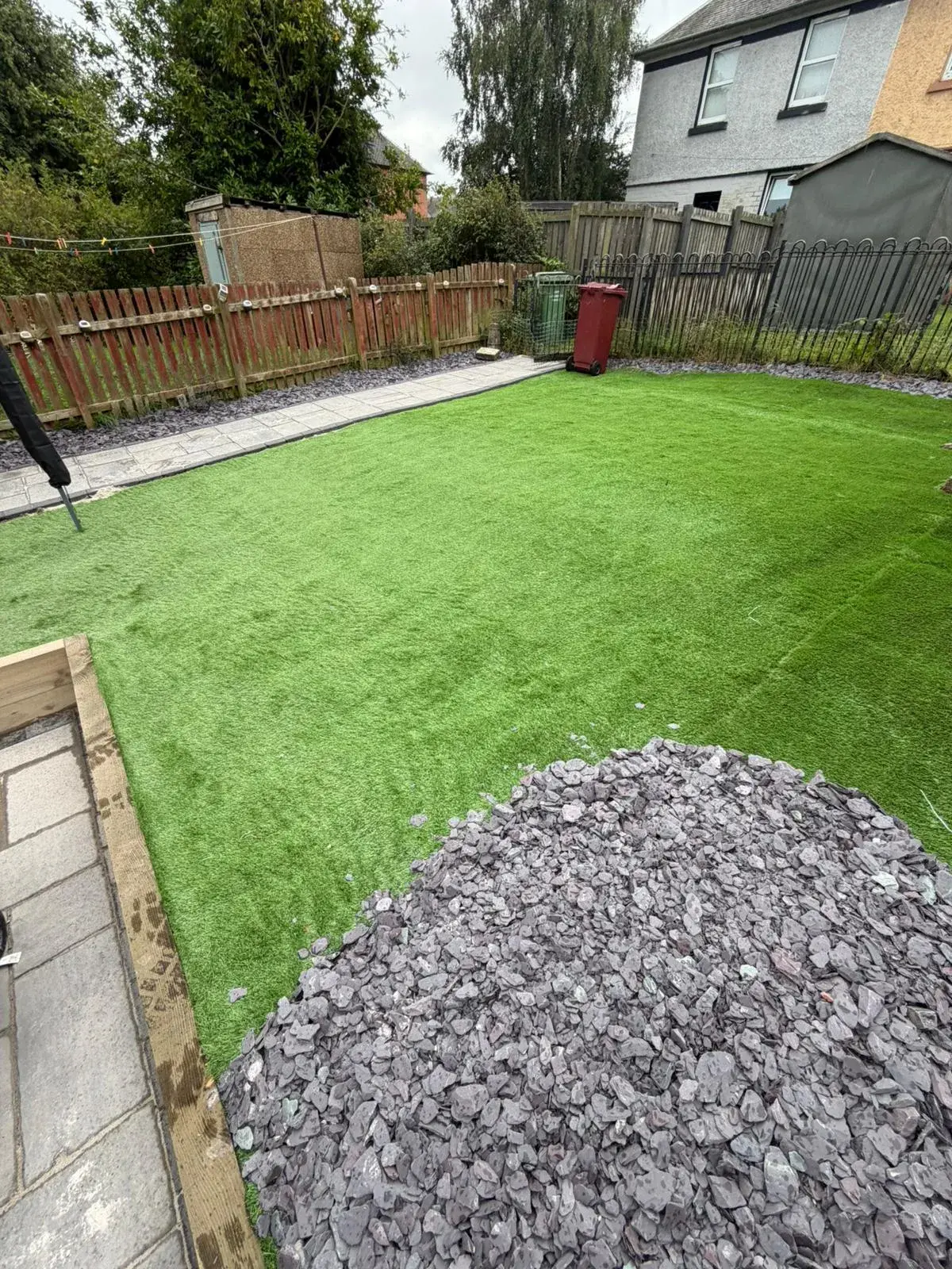 Artificial grass installation with raised border